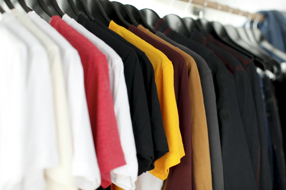 An assortment of clothes on hangers